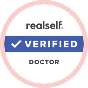 Blue verified badge with a checkmark inside a circular pink outline, indicating authenticity and trustworthiness.