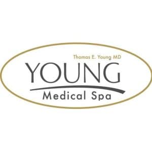 Logo of Young Medical Spa, featuring the name prominently in a modern font. The design includes the text "Thomas E. Young MD" above the main logo, emphasizing the professional credentials of the medical spa. The color scheme is elegant, with a combination of dark gray and gold accents, conveying a sense of luxury and professionalism. This logo represents a facility specializing in aesthetic and medical treatments, promoting wellness and beauty. Ideal for use in branding and marketing materials to enhance online visibility and accessibility.